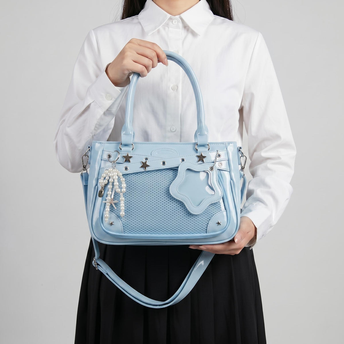 Yume Dual Window Shoulder Ita Bag worn over the shoulder, display window filled with photocards and pins
