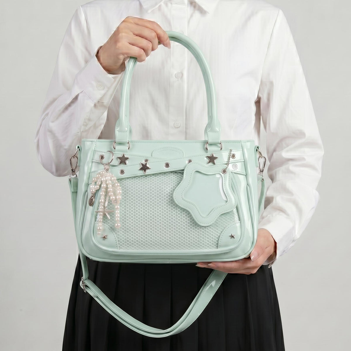 Yume Dual Window Shoulder Ita Bag studio three-quarter view showing rectangular front window and star-shaped side window together