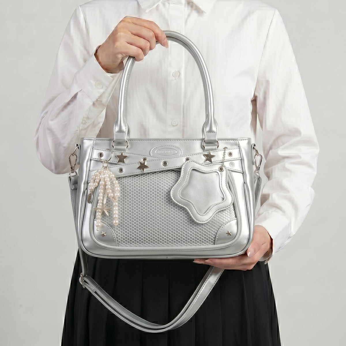 Yume Dual Window Shoulder Ita Bag studio front view showing structured PU leather frame, star hardware, and display window