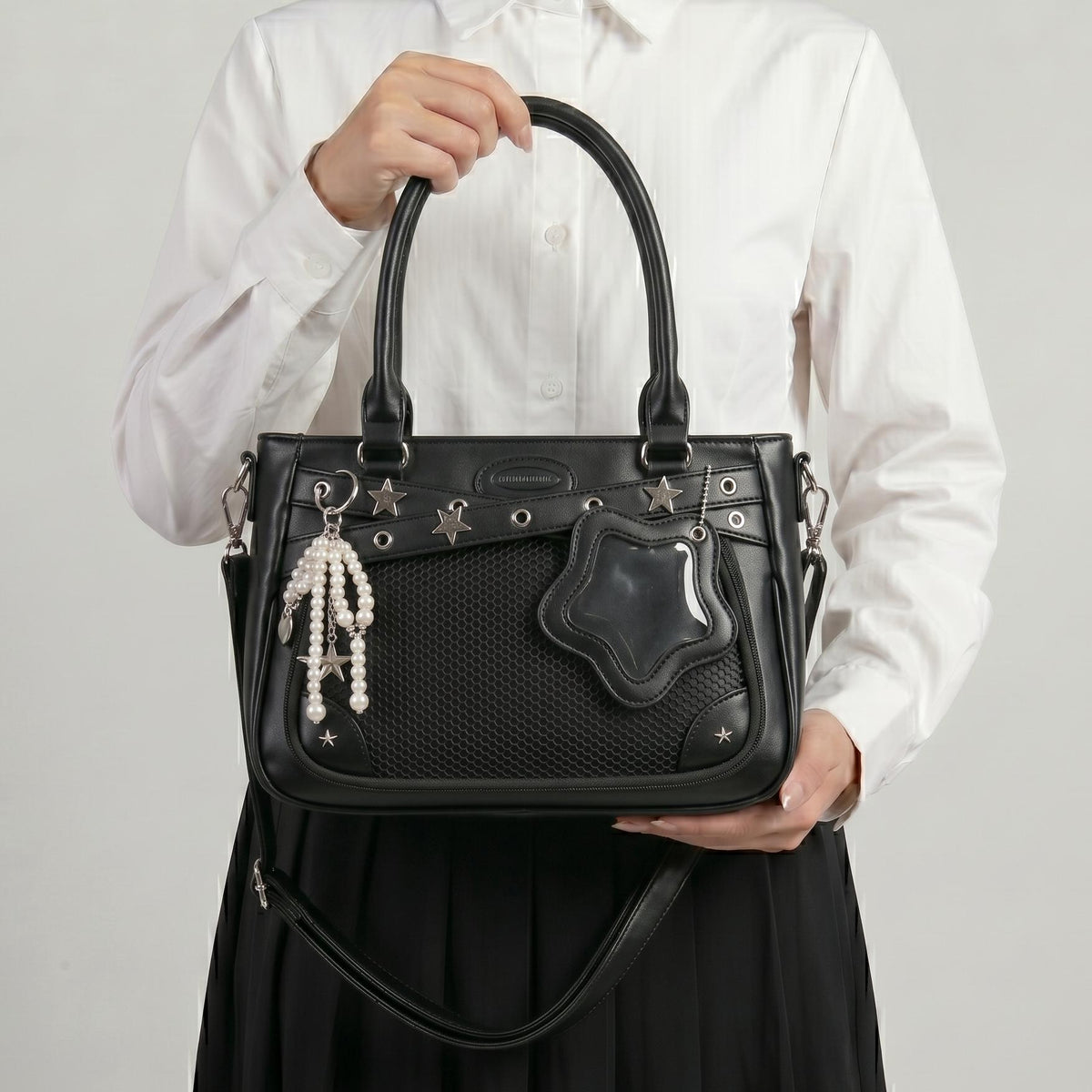Yume Dual Window Shoulder Ita Bag studio side angle showing star-shaped side window, structured depth, and strap hardware